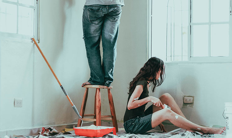 A couple painting their bedroom